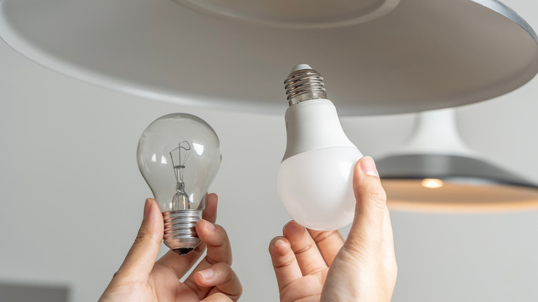 Someone swapping out light bulbs