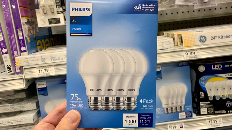 Hand holding box of Philips lightbulbs