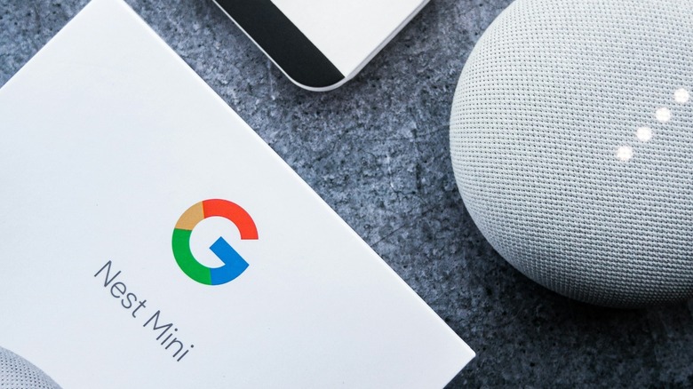 Google Nest Mini smart home speaker with packaging on floor