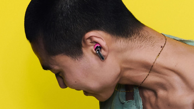 Close-up of a person wearing the Nothing Ear 3a wireless earbuds