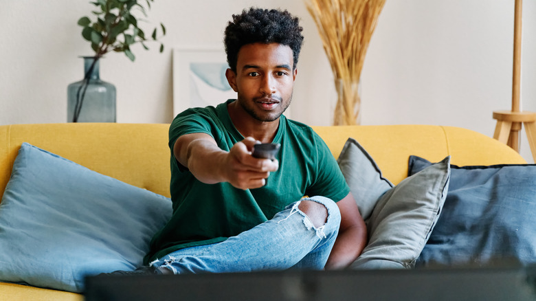 man using tv remote