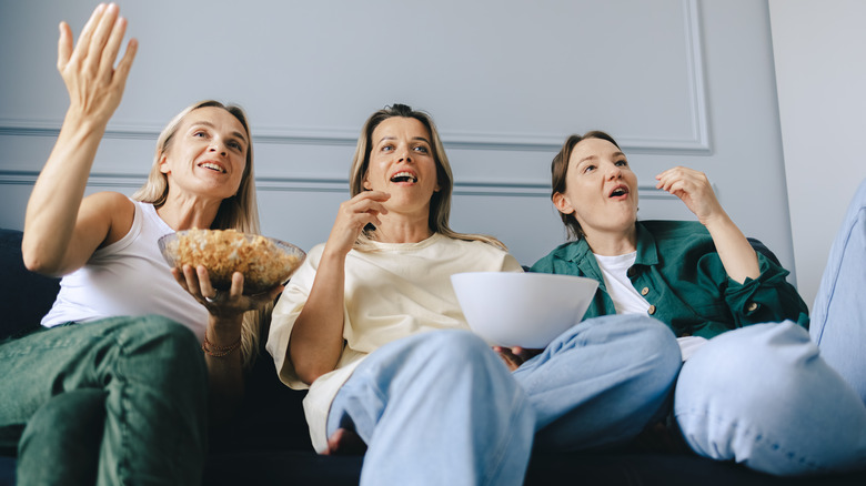 women watching tv with popcorn