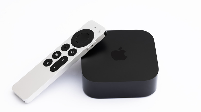An Apple TV 4K (3rd generation) white remote reting on an Apple TV streaming box
