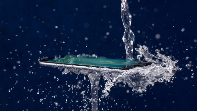 A phone being splashed with water.