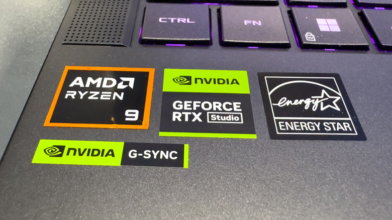 A close-up of AMD Ryzen and Nvidia GeForce RTX stickers on a laptop