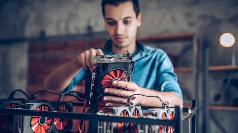 A man attaching graphics cards to a PC