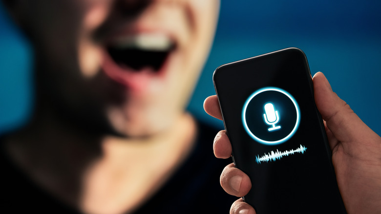 A person using a smartphone to record a voice memo