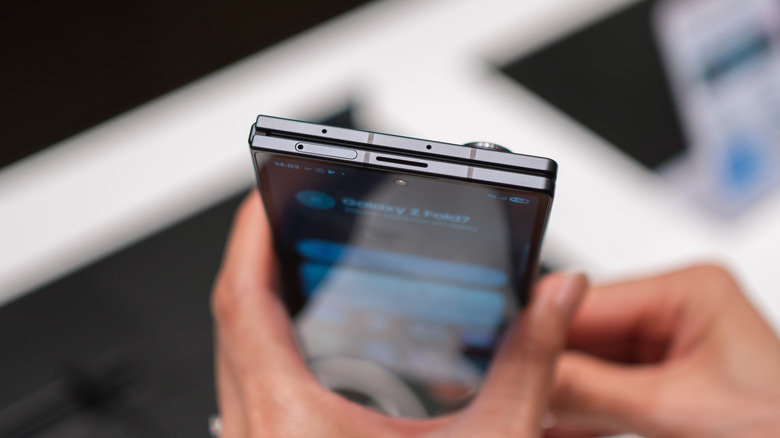 A person holding a Galaxy Z Fold 7 in compact form