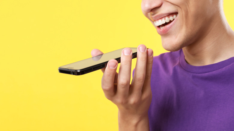 A person speaking into a smartphone