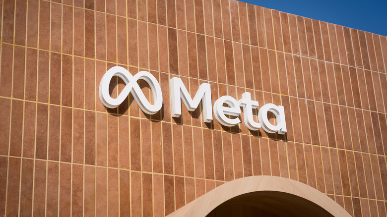 The Meta company logo is seen on a wall