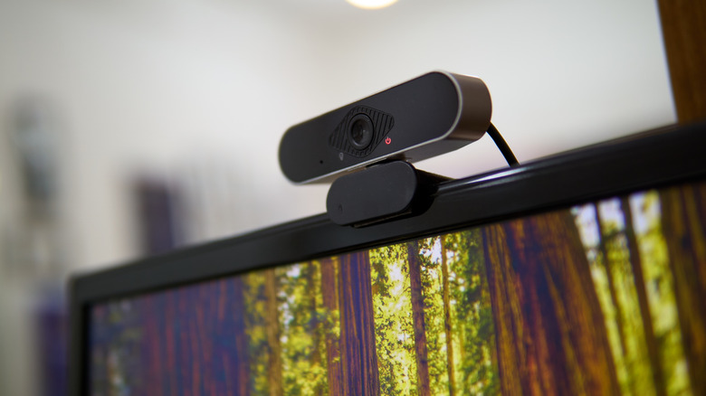 Black modern webcam mounted on top of a monitor