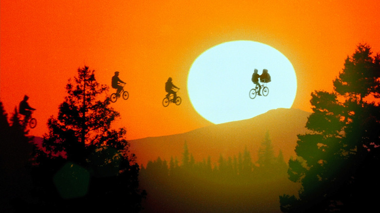 Bikers float in front of a setting sun in the iconic scene from E.T. (1982)