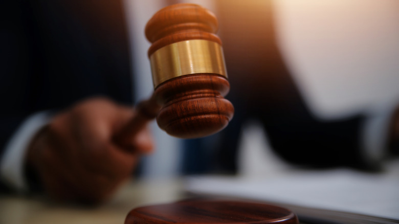 a judge holding a gavel in a courtroom