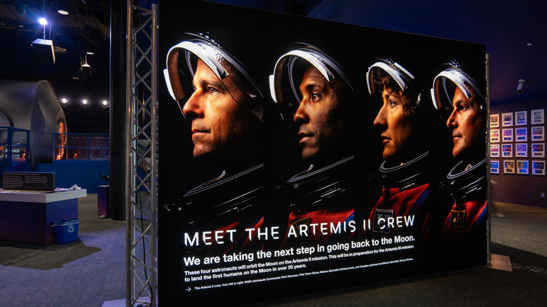 NASA billboard for the Artemis II crew featuring headshots of each crew member wearing their spacesuit.