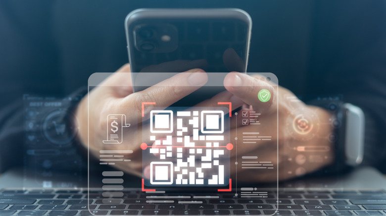 Virtual image of a QR code being scanned by a phone