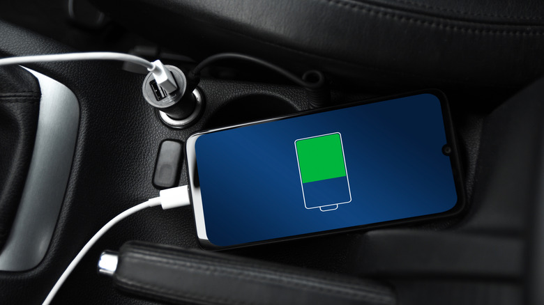 A smartphone charging quickly via 12V USB adapter