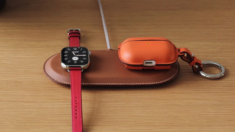 The Paddock Duo charger with an Apple Watch and AirPods charging on it.