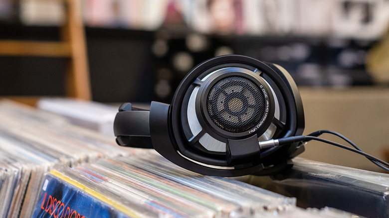 The Sennheiser HD 800 headphones resting on a bin filled with vinyl records