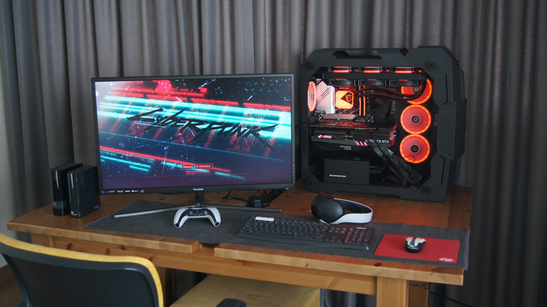 A desk setup with a PC, monitor, and other accessories