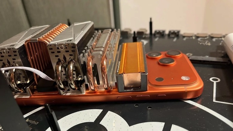An iPhone 17 Pro Max cooled with M2 SSD heatsinks.