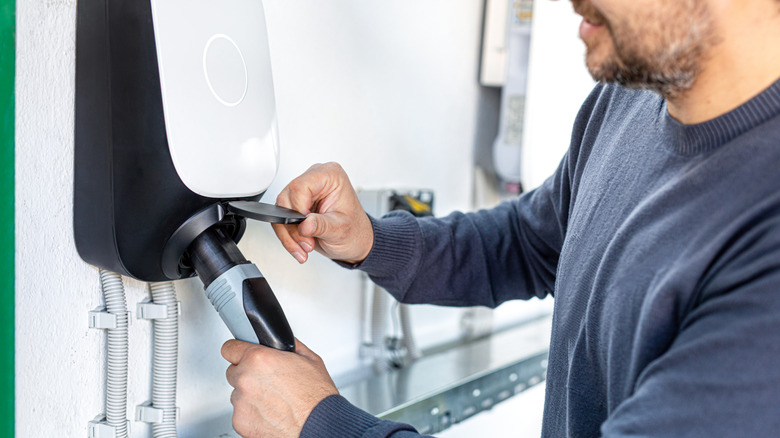 Man plugging in an EV charger