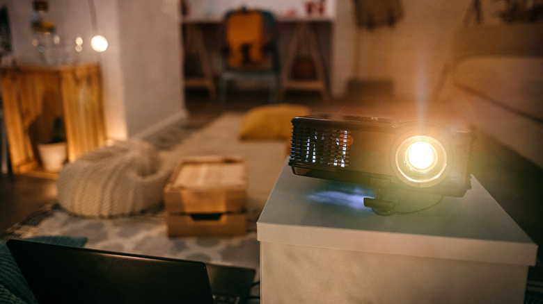 Close up of a projector lamp inside the housing with light extending out.