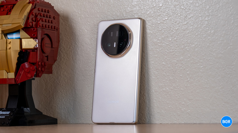 Honor Magic V5, folded and leaning against a wall