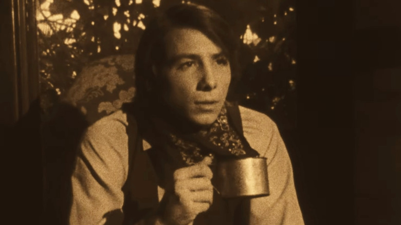 Broncho Billy (Johnny Crawford) sitting down in 