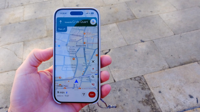 Person holding Google Maps open on a smartphone.