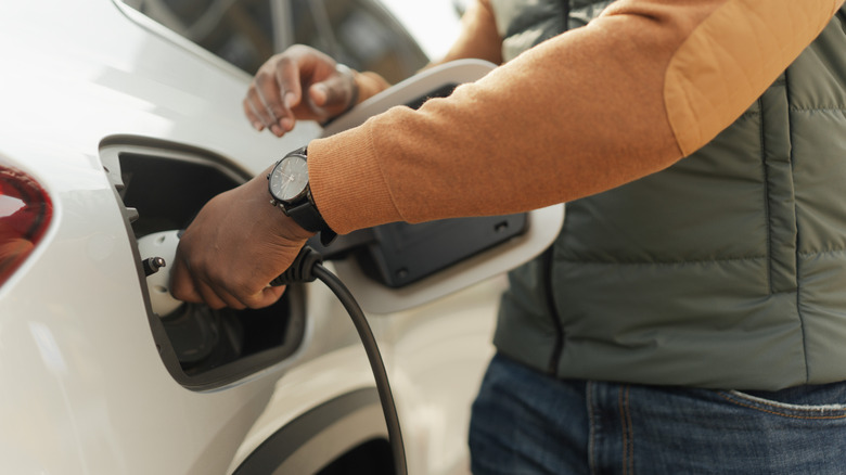 a man charging his electric vehicle EV