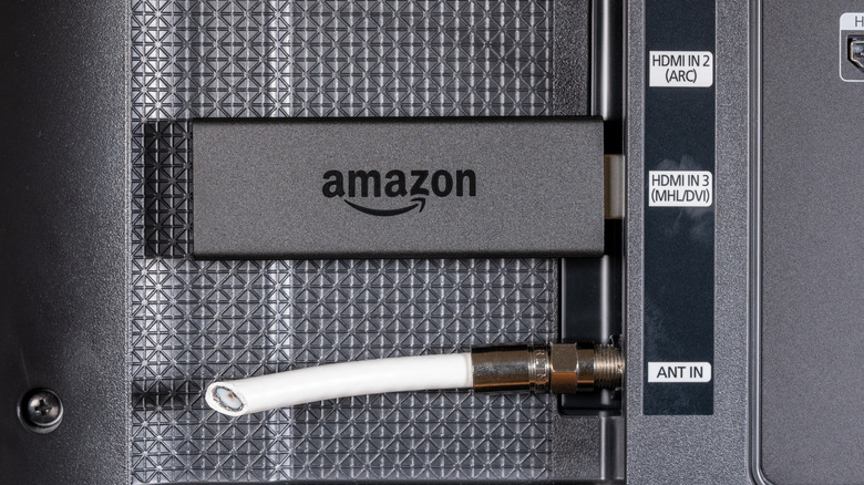 An Amazon Fire TV Stick plugged into a TV