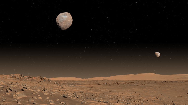 Mars' surface, with Phobos and Deimos in the background.