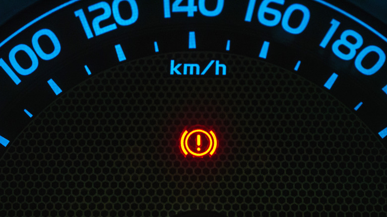 A close-up photo of an on-screen dashboard warning light in a car.