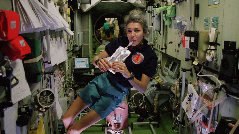 ESA astronaut Claudie Haigneré seen drinking from a strawed water pouch on the ISS