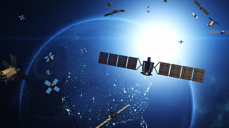 Advancing Telecommunication and High-Speed Internet. Satellites Flying Around Earth. Industry And Technology Related 3D Render.