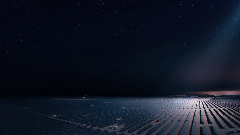 concept of a satellite illuminating a solar farm at night