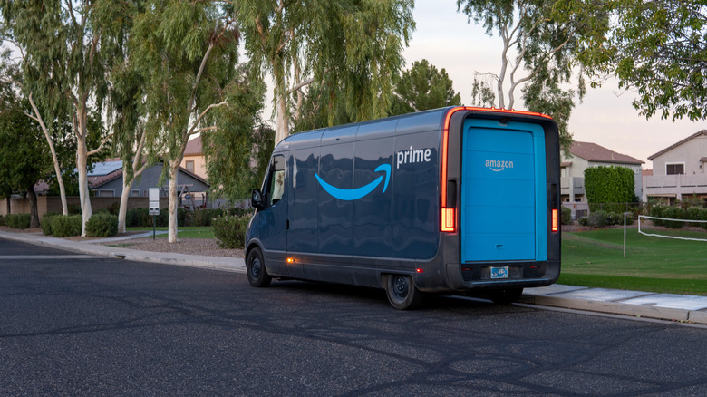 An Amazon delivery truck parked in a suburban neighborhood.