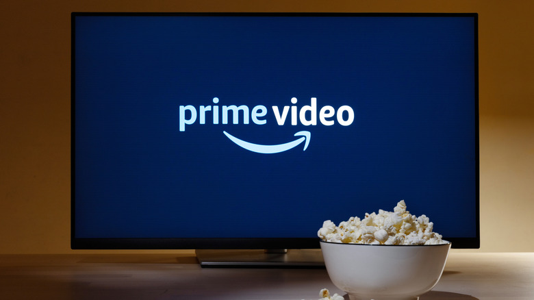 the Amazon Prime video logo on a TV screen with a bowl of popcorn next to it