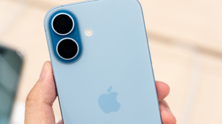 Hand holding iPhone 17 blue color