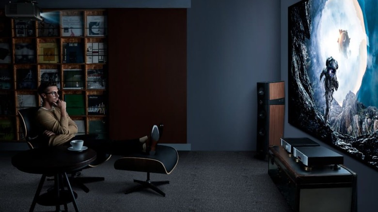 A man watching movie on a W4100i Home Cinema Projector