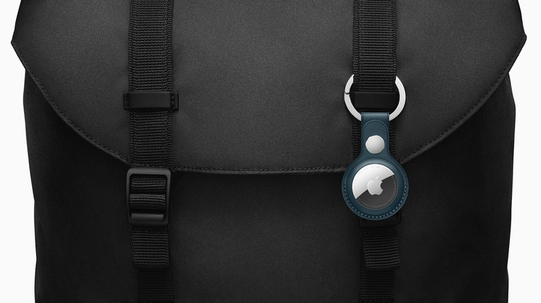 An Apple AirTag on the strap of a backpack