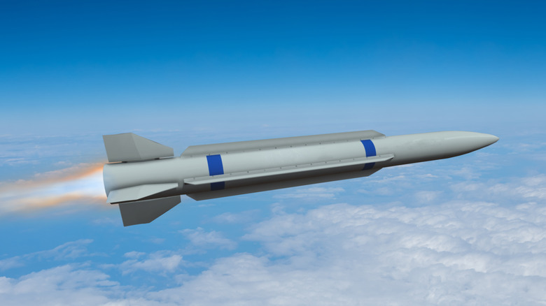 Side view of a hypersonic missile flying mid-air at a high altitude