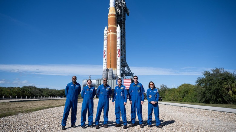 The crew and their backups in front of the Artemis 2 rocket and Orion