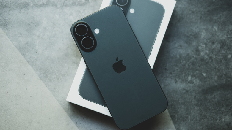 The iPhone 17 on top of its retail box.