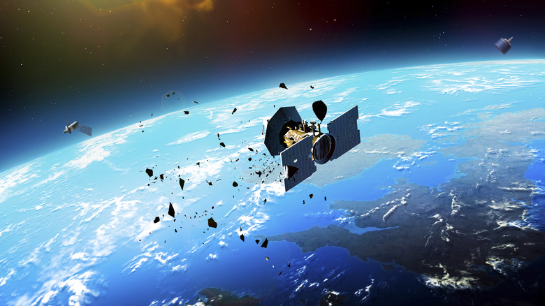 Satellite in low Earth orbit with space debris surrounding it.