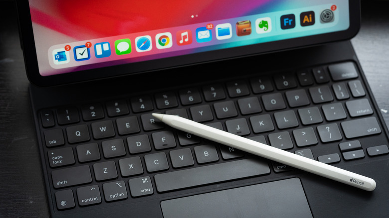 An Apple Pencil sitting on top of a iPad Magic Keyboard