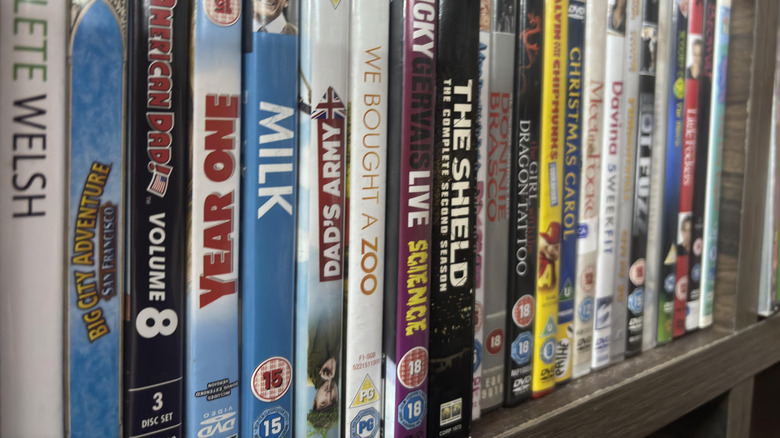 A collection of DVD movies stored vertically
