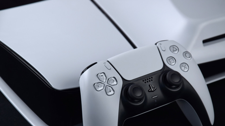DualSense controller on top of PlayStation 5 game console