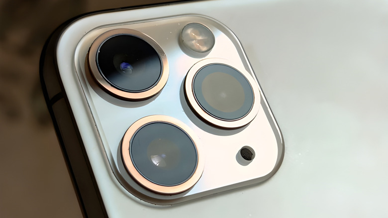 A close-up of an iPhone's camera module which contains the flash/flashlight.