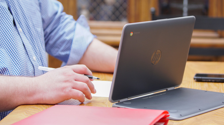 HP Chromebook in propped up configuration on table.